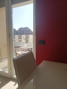 a room with a chair and a table and a window at G.V. Suite Torino - Bilocale in Turin