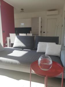 a bed with a red table and a glass bowl on it at G.V. Suite Torino - Bilocale in Turin