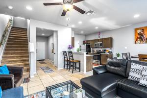 a living room with a couch and a kitchen at SA Family Home 3BR 3BA Home w 12 Arcade Games & HotTub- 5mins to Airport w Private Garage in San Antonio
