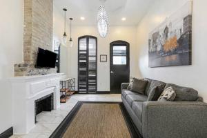 a living room with a couch and a fireplace at Sleep 10 next to Superdome and downtown in New Orleans