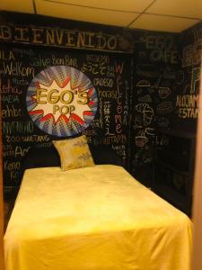 a bedroom with a black wall with writing on it at Casa Egos Pop Laureles in Medellín
