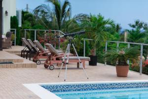 a camera on a tripod next to a pool at Seascape Villa in Montego Bay