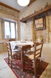 a dining room with a wooden table and chairs at House Trevisol in Rovinj +19 photos