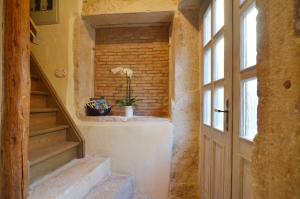a staircase in a house with a brick wall at House Trevisol in Rovinj