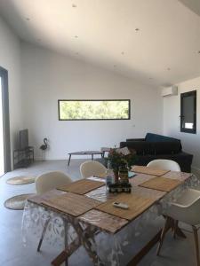 ein Wohnzimmer mit einem Tisch und Stühlen in der Unterkunft Villa Isula Contemporaine Piscine chauffée in Palasca