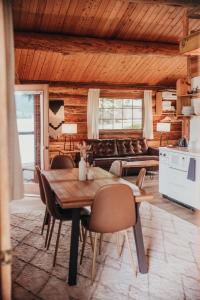 a kitchen and dining room with a table and chairs at Wilder and Pine Riverside Cabins in Stevenson