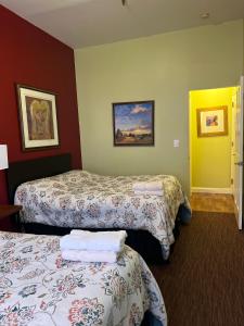 a hotel room with two beds and a yellow door at Adelaide Hostel in San Francisco