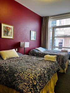 a hotel room with two beds and a window at Adelaide Hostel in San Francisco