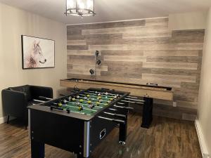 a foosball table in a room with a wall at 22- Chalet à Louer à Stoneham in Stoneham