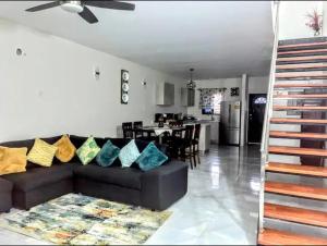 een woonkamer met een bank en een eetkamer bij Wynters'Escape-gated 1 or 2 Bedroom w PuertoSecoBeach access in Discovery Bay