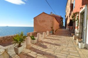 a cobblestone street in a town next to the ocean at House Trevisol in Rovinj