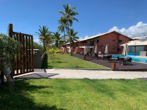 a view of a resort with a pool and a building at Paraiso Pe na Areia entre Ilhéus e Itacare in Ilhéus