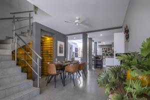 a dining room with a table and chairs and stairs at Casa Saidera in Playa Blanca
