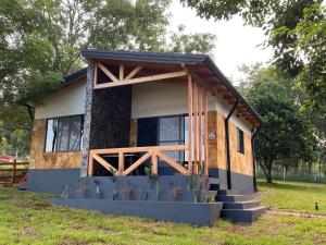 a tiny house in a field with a porch at Casa de Campo Fichtelberger Hohenau in Hohenau