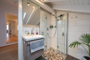 a bathroom with a sink and a shower at Ferienwohnung #TIMEOUT in Pfronten