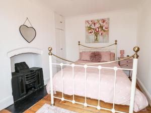 a bedroom with a bed and a fireplace at 20 Crown Street in Newark-on-Trent