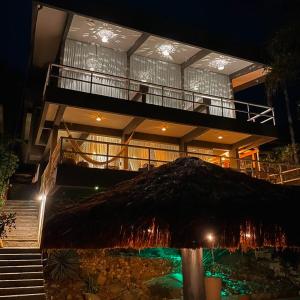 a large building with a large umbrella in front of it at Casa pé na areia para até 14 pessoas em bombinhas in Bombinhas