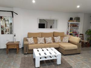 a living room with a couch and a coffee table at Acogedor apartamento loft in Alhaurín de la Torre +36 photos