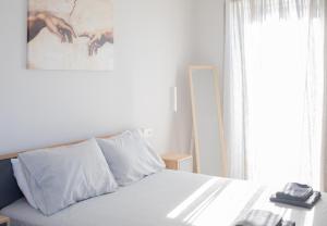 a bedroom with a bed and a painting on the wall at Live the Local Life , Old Town Kos in Kos