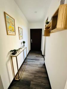 a hallway with a black door and a room with a table at Habitación privada in Guatemala