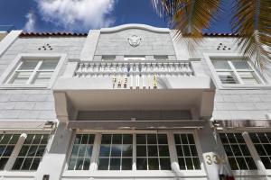 a white building with a clock on it at The Julia Hotel in Miami Beach