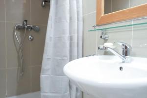 a bathroom with a sink and a shower curtain at Apartman Sakovic in Kopaonik