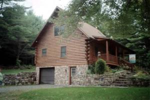 a large wooden house with a garage in the yard at The Old Tioga Inn Bed and Breakfast in Fairmount Springs