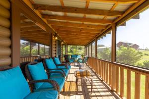 a screened porch with blue chairs on it at Chapel Cove in Dandridge