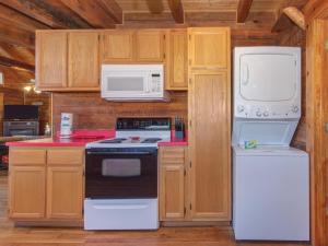 a kitchen with white appliances and wooden cabinets at Chapel Cove in Dandridge +46 photos
