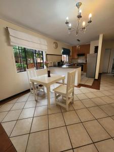 a kitchen and dining room with a table and chairs at 2a - 64 No load shedding 2bed 2bath with garden in Centurion