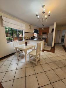 a kitchen and dining room with a table and chairs at 2a - 64 No load shedding 2bed 2bath with garden in Centurion +23 photos