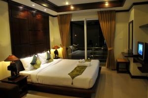 Cama o camas de una habitación en Boonjumnong Modern Apartment