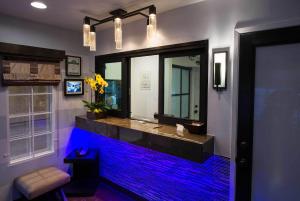 a bathroom with a large aquarium with blue lights at Regency Inn in Los Angeles in Los Angeles