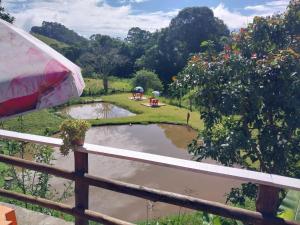 a view of a pond from a fence at Pousada Beija flor in Extrema