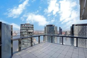 a view of a city from the balcony of a building at Orange Stay Apartments in Melbourne