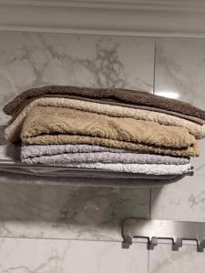 a pile of towels sitting on a shelf in a bathroom at Friendly House in Jurmala in Jūrmala
