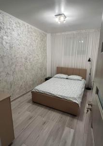 a bedroom with a bed in the middle of it at MODERN & ELEGANT Apartament in Craiova