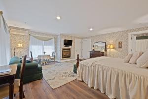 a bedroom with a bed and a living room at Brook Farm Inn in Lenox