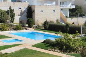 a swimming pool in a yard with a building at Ericeira Chill Hill Hostel & Private Rooms in Ericeira