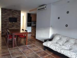 a living room with a couch and a table at Casa Quinta Barrio Real in Junín