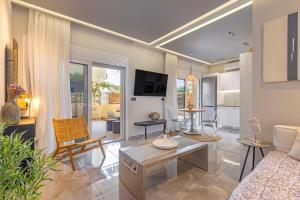 a living room with a couch and a table at Elia & Anthos Deluxe Suites in Ixia