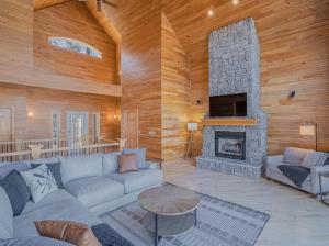 a living room with a couch and a fireplace at Amazing Vacation Home on the 56 MM, Dock, Water Toys, Fire Pit, 5 bedrooms/5 baths in Laurie