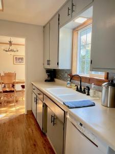 una cocina con armarios blancos y fregadero en Charming 4B 2B Home In Exclusive Neighborhood of Eureka, en Eureka