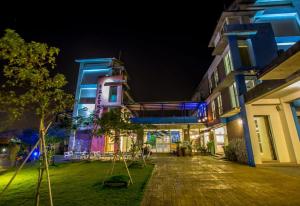a building with a walkway in front of it at night at Vanilla Twilight in Wujie