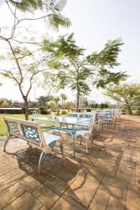 a row of tables and benches in a park at Vanilla Twilight in Wujie