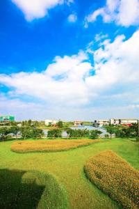 a park with a field of flowers and a river at Vanilla Twilight in Wujie