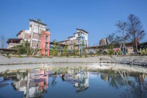 a reflection of a building in a body of water at Vanilla Twilight in Wujie