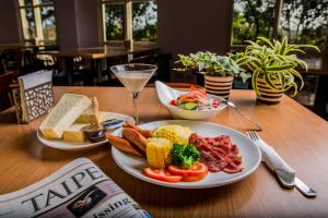 a table with two plates of food and a glass of wine at Vanilla Twilight in Wujie