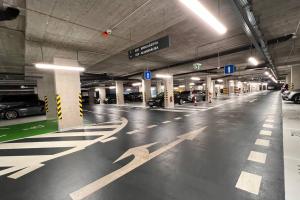 an empty parking garage with cars parked in it at 2 room apartment, Old City, new building - Stein in Bratislava