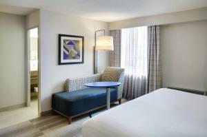 a hotel room with a bed and a chair and a table at Holiday Inn Express Toronto Downtown, an IHG Hotel in Toronto